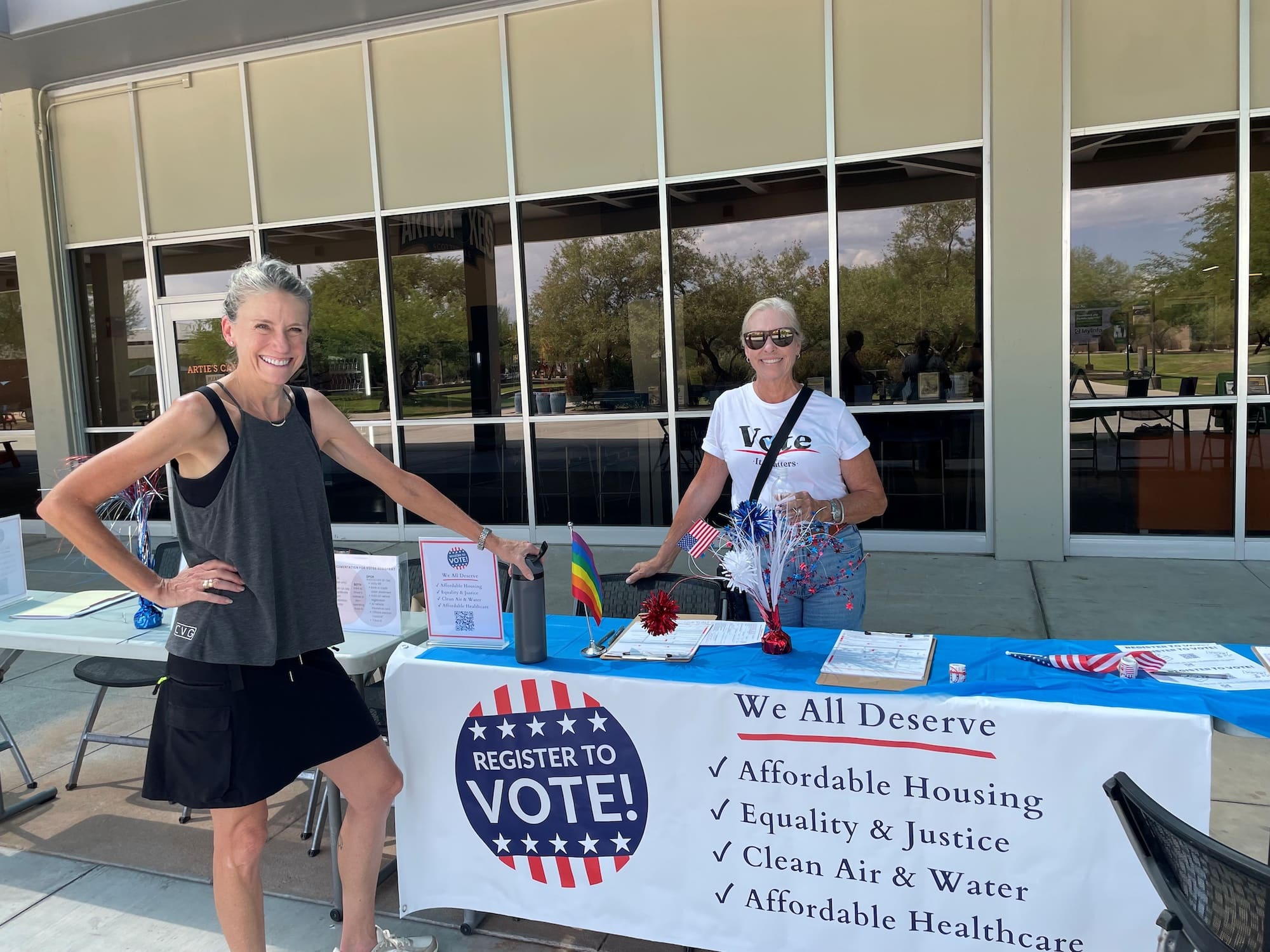 Two volunteers staffing a voter registration table in Arizona.